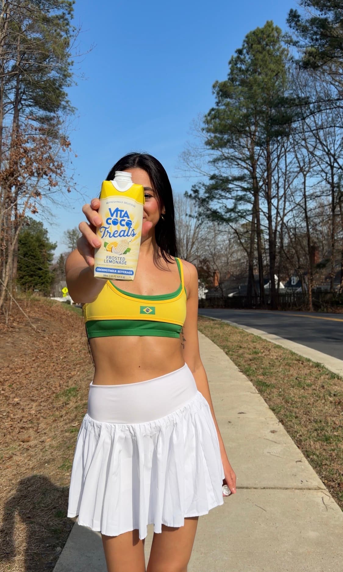 Julia Jones holding a Vita Coco Treats drink outdoors